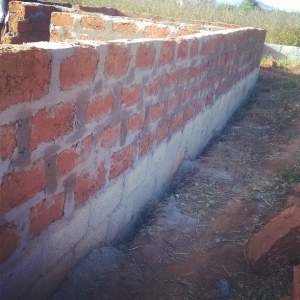 MUD BRICKS IN USE FOR BUILDING WITH SAND AND CEMENT BLOCKS AS FOUNDATION. 